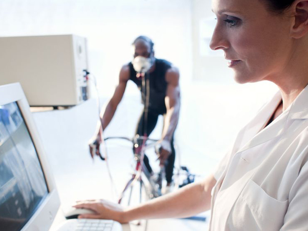 female doctor monitoring ventilation of a man on a bicycle